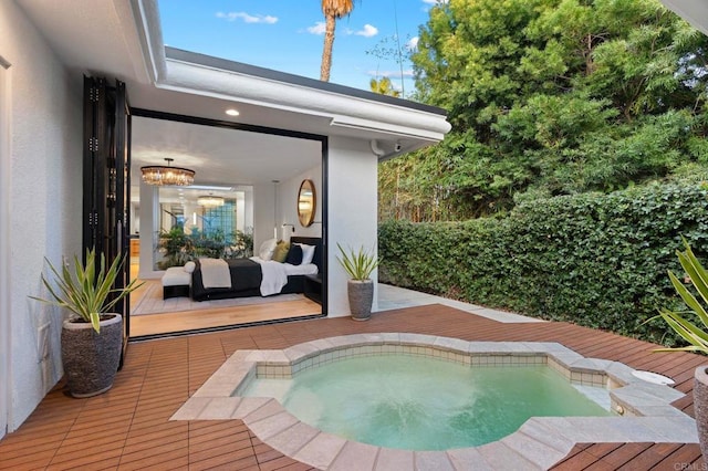 view of swimming pool featuring a deck and an in ground hot tub