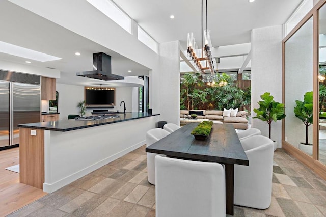 dining space featuring a chandelier, stone finish flooring, and recessed lighting