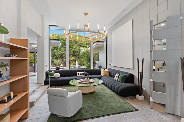 sunken living room featuring an inviting chandelier, expansive windows, and tile walls