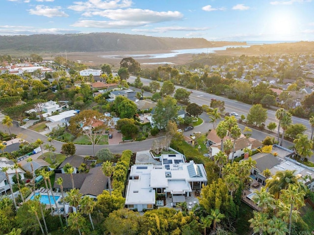 drone / aerial view featuring a residential view and a water view