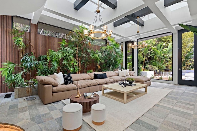 sunroom / solarium featuring an inviting chandelier, coffered ceiling, and beamed ceiling