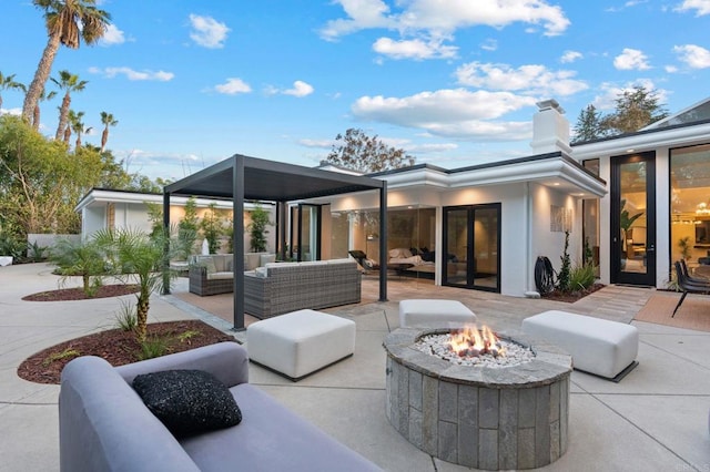 view of patio featuring an outdoor living space with a fire pit