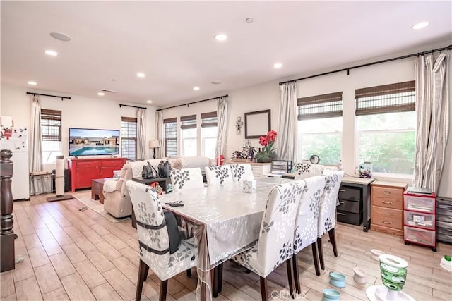 dining area featuring light wood-type flooring and recessed lighting