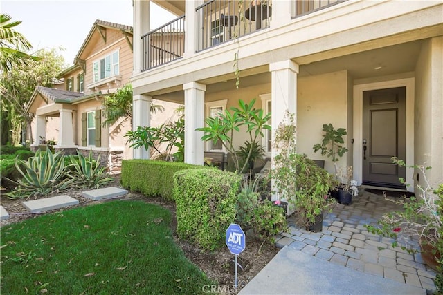 exterior space with a balcony and stucco siding