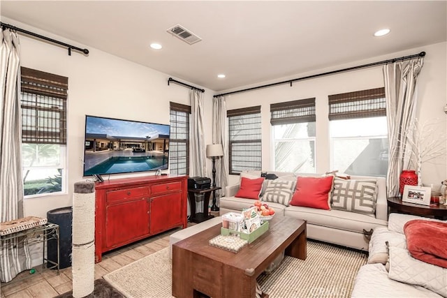 living room featuring light wood-style floors, recessed lighting, and visible vents