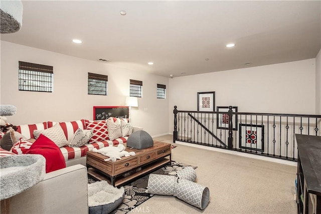 carpeted living area featuring visible vents and recessed lighting