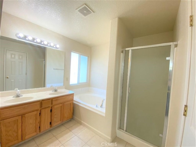 full bathroom featuring a stall shower, visible vents, a sink, and a garden tub