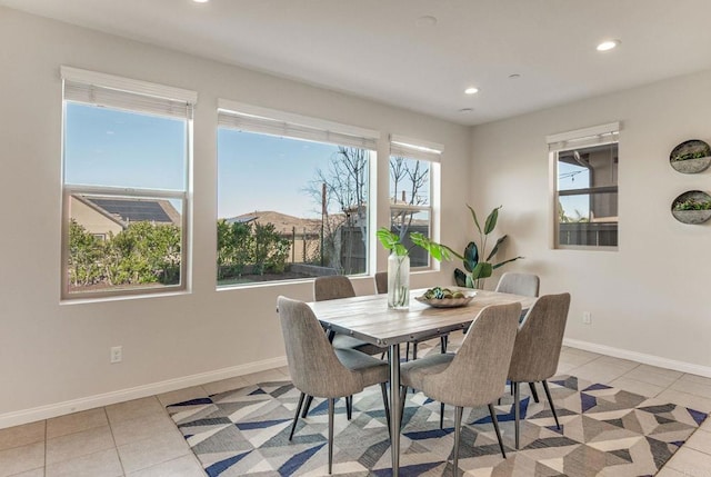 dining space featuring light tile patterned floors, baseboards, and recessed lighting