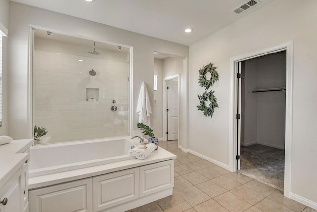 full bath featuring a washtub, a tile shower, visible vents, and baseboards