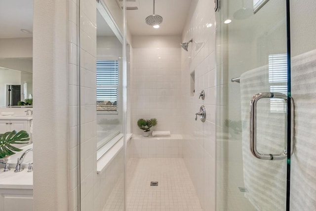 full bathroom with a shower stall and vanity