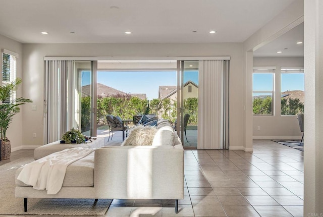 tiled living room with baseboards and recessed lighting