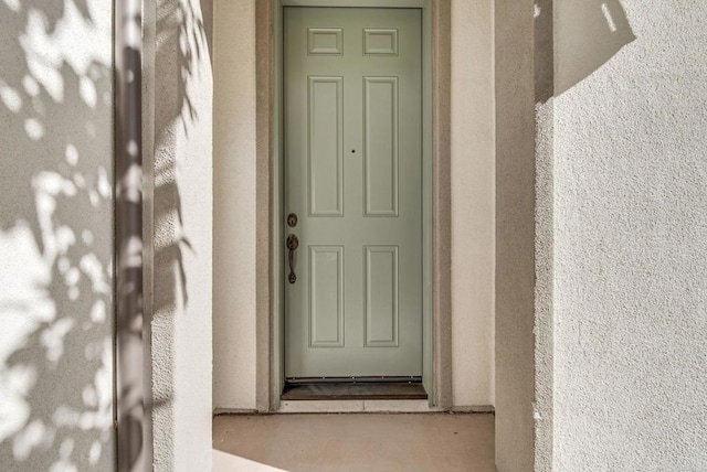 doorway to property with stucco siding