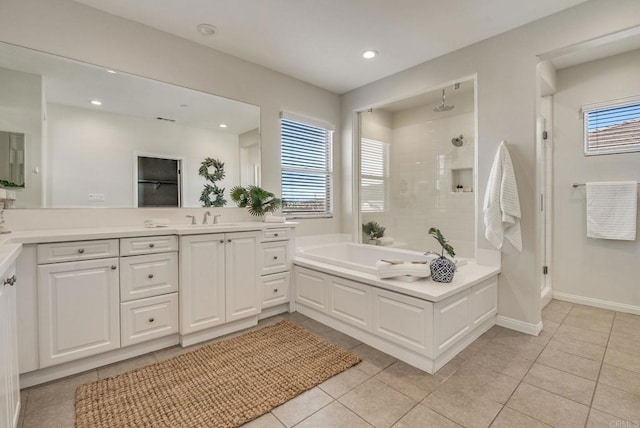 bathroom featuring tile patterned flooring, a garden tub, a shower stall, and vanity