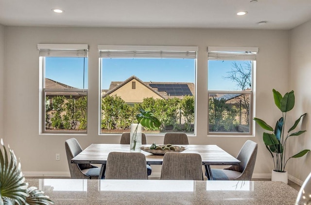 dining space featuring baseboards, recessed lighting, and a healthy amount of sunlight