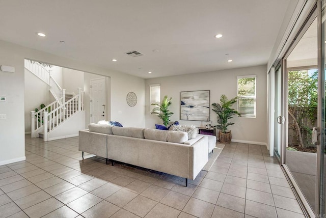 living room with light tile patterned floors, recessed lighting, visible vents, stairway, and baseboards