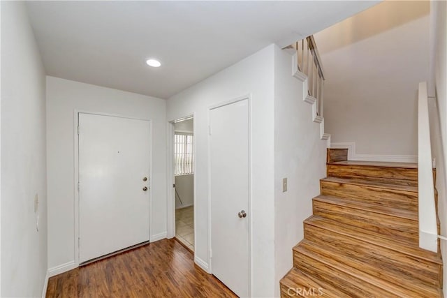 entryway featuring stairway, recessed lighting, baseboards, and wood finished floors