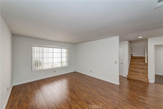 spare room featuring visible vents, recessed lighting, baseboards, and wood finished floors