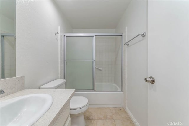 bathroom with enclosed tub / shower combo, toilet, vanity, and tile patterned flooring