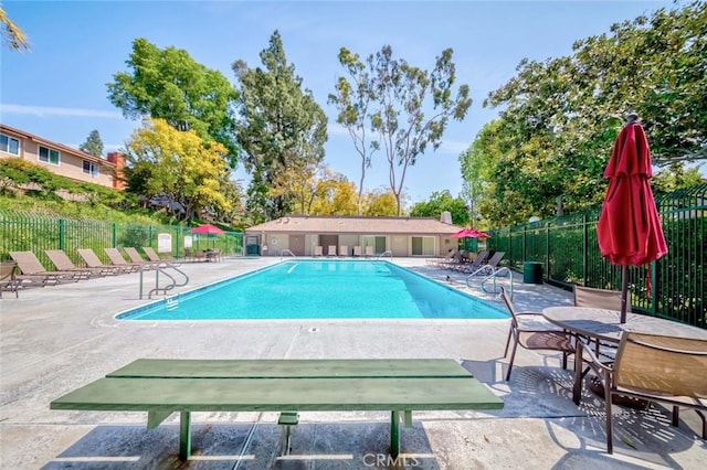 pool featuring a patio and fence