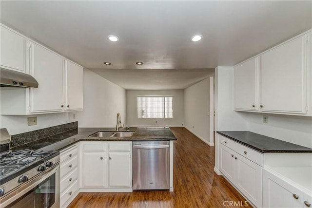 kitchen with a sink, appliances with stainless steel finishes, and white cabinets