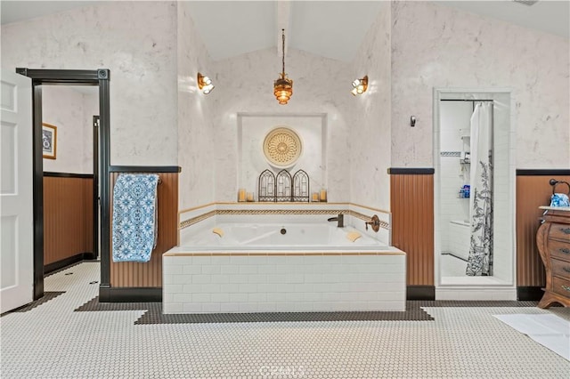 bathroom with wallpapered walls, a shower, wainscoting, lofted ceiling with beams, and a garden tub