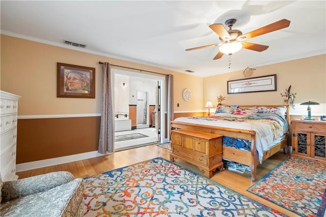 bedroom with ornamental molding, wood finished floors, and visible vents