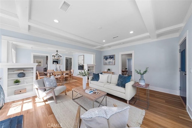 living room featuring baseboards, visible vents, beamed ceiling, wood finished floors, and a chandelier