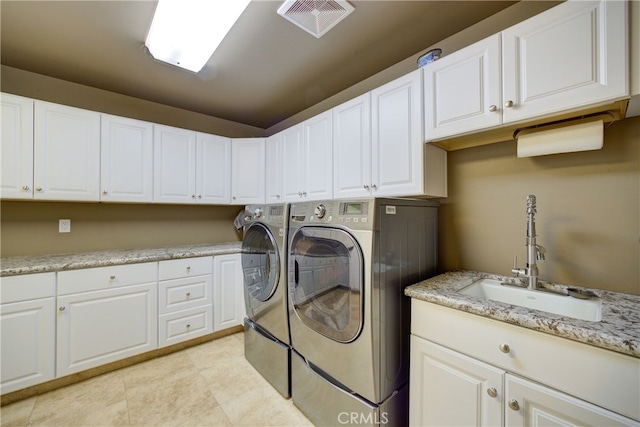 515 Windermere Ln, Arroyo Grande, CA 93420 - clothes washing area with washing machine and dryer, cabinet space, and light tile patterned floors