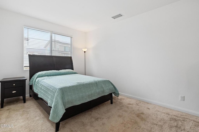 bedroom featuring carpet floors, visible vents, and baseboards