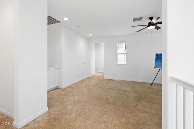 unfurnished room featuring light colored carpet, recessed lighting, visible vents, and baseboards