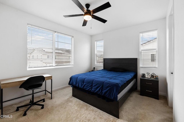 carpeted bedroom featuring ceiling fan and baseboards