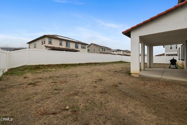 view of yard featuring a patio and a fenced backyard