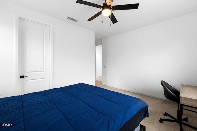 carpeted bedroom with visible vents and a ceiling fan