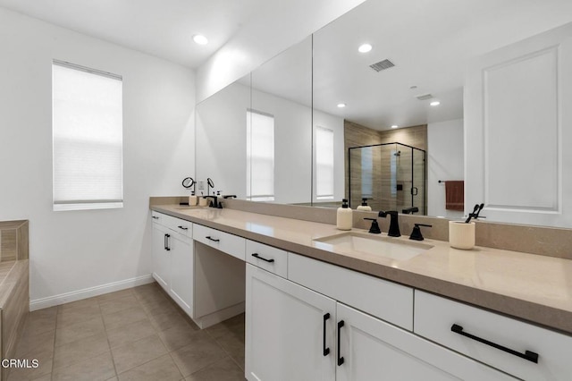 full bathroom featuring a stall shower, a healthy amount of sunlight, visible vents, and a sink