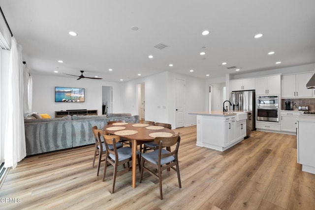 dining room featuring a ceiling fan, light wood-type flooring, visible vents, and recessed lighting