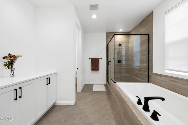 bathroom featuring a stall shower, visible vents, baseboards, tile patterned flooring, and a bath