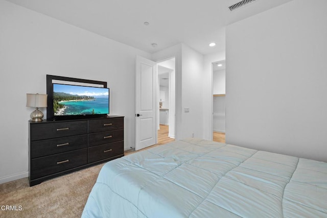 bedroom with light colored carpet, visible vents, baseboards, and recessed lighting