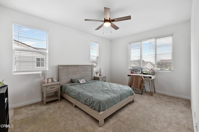 bedroom with a ceiling fan, carpet flooring, and baseboards