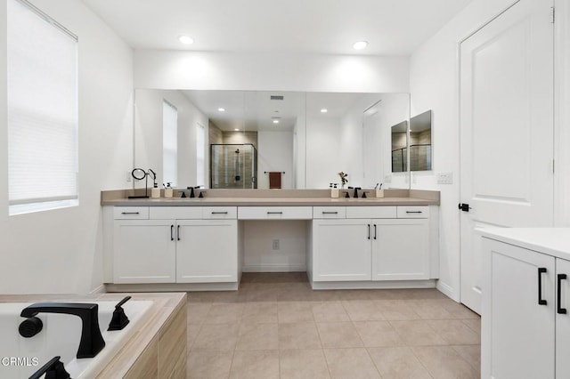 bathroom with recessed lighting, a stall shower, tile patterned floors, and vanity