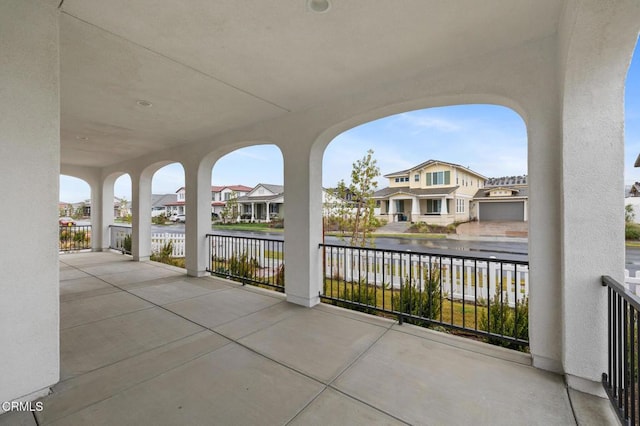 view of patio featuring a residential view and a water view