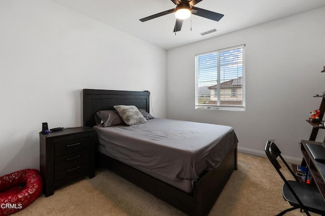 bedroom with light carpet, ceiling fan, visible vents, and baseboards