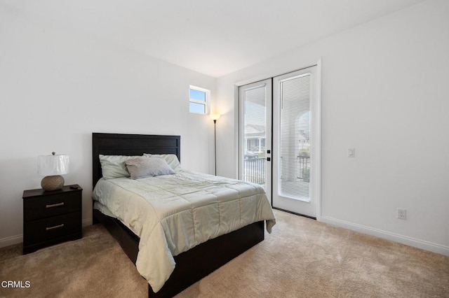 carpeted bedroom featuring baseboards and access to exterior