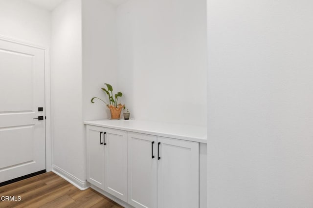 interior space featuring wood finished floors and baseboards