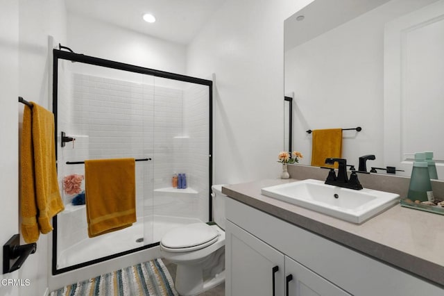 full bathroom with vanity, a shower stall, toilet, and recessed lighting