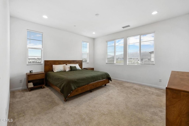 carpeted bedroom with multiple windows, recessed lighting, and baseboards