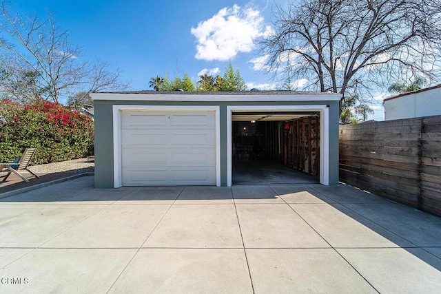 detached garage featuring fence