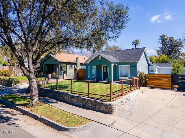 single story home with a fenced front yard, a front yard, a gate, and stucco siding