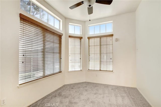 carpeted empty room featuring ceiling fan