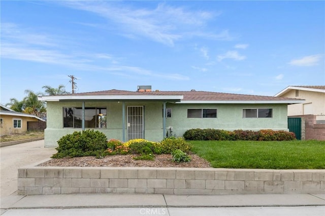 single story home with fence, a front lawn, and stucco siding