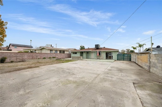 view of front of home with cooling unit, a gate, and fence